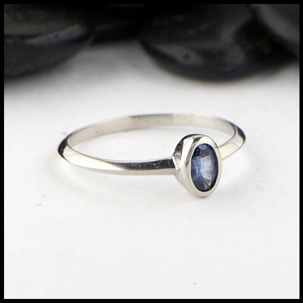 Simple 14K White Gold ring bezel set with a 0.36ct Oval Ceylon Blue Sapphire. 