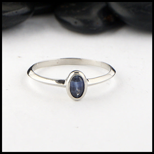 Simple 14K White Gold ring bezel set with a 0.36ct Oval Ceylon Blue Sapphire. 