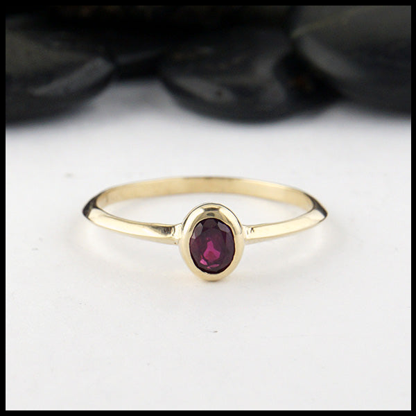 Simple 14K Yellow Gold ring bezel set with a 0.47ct 5x4mm oval Ruby.