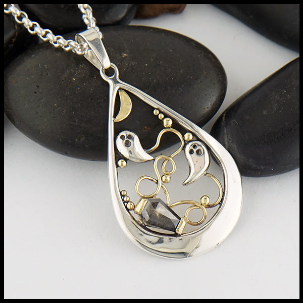 Custom Ghost Pendant in Sterling Silver featuring silver ghosts and 14K Yellow gold moon, ghost trails, and accent beads.  The coffin shaped salt and pepper diamond is 0.63 ct measuring 7.3mm x 4.9mm.  